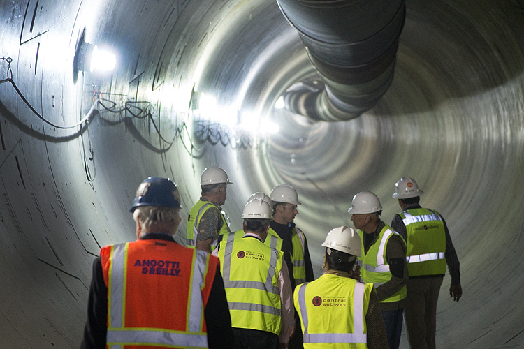 construction crew inspecting an underground tunnel